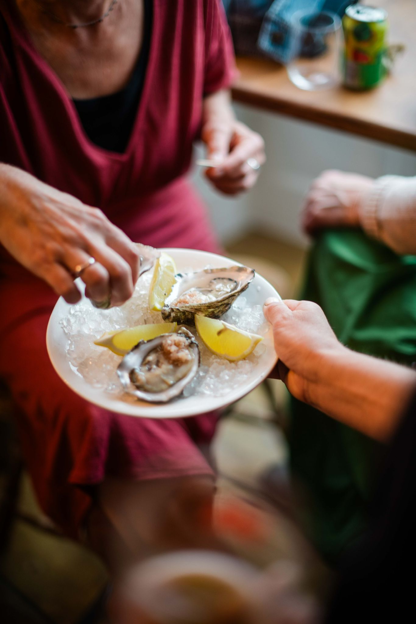 Guests sharing fresh oysters with lemon