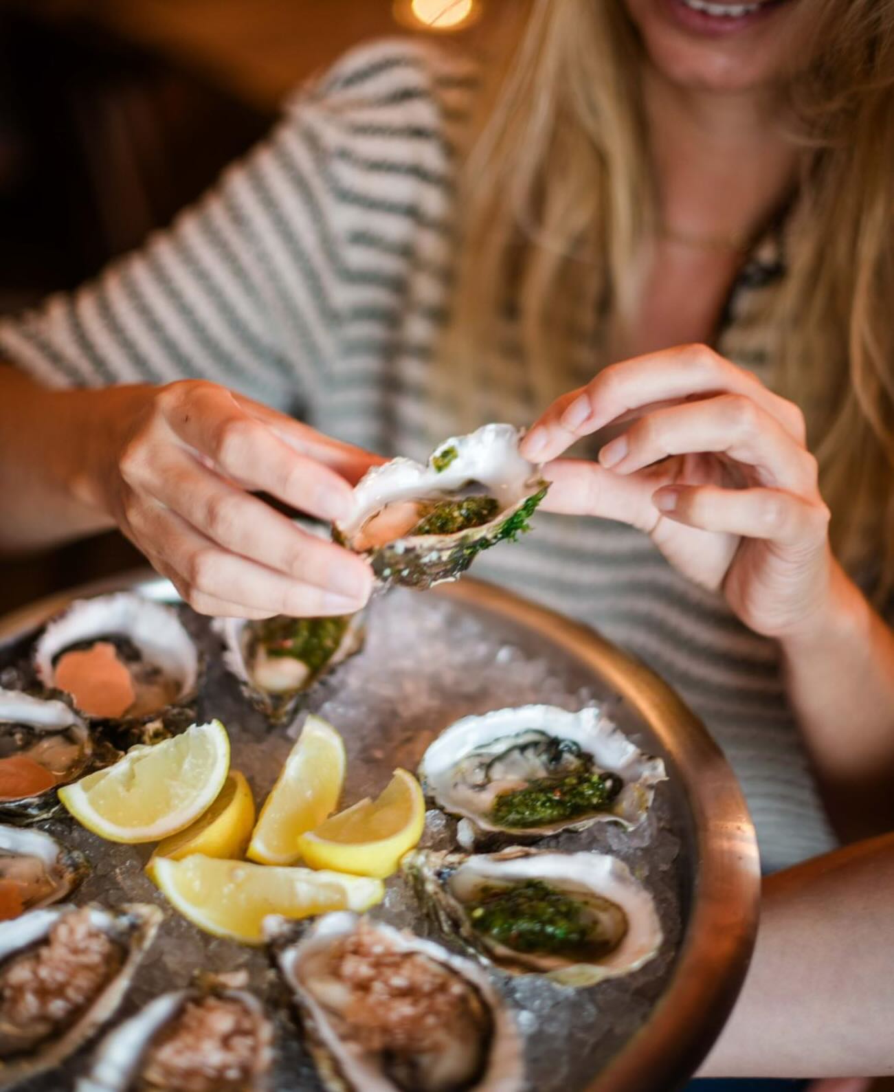 Guests enjoying freshly shucked oysters at the table